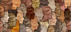 Silhouettes of faces in different skin tone colored papers
