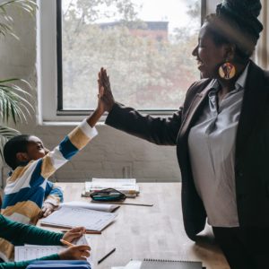 woman and student High-Fiving