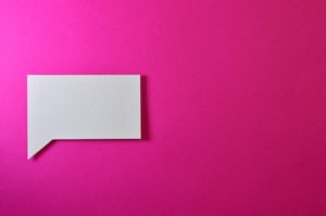 Pink background with white square speech bubble