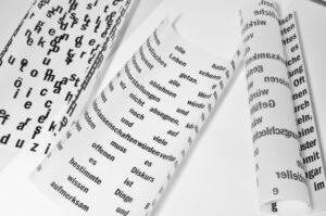 letters and words on paper in various languages