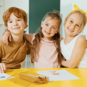 Smiling kids at an art table